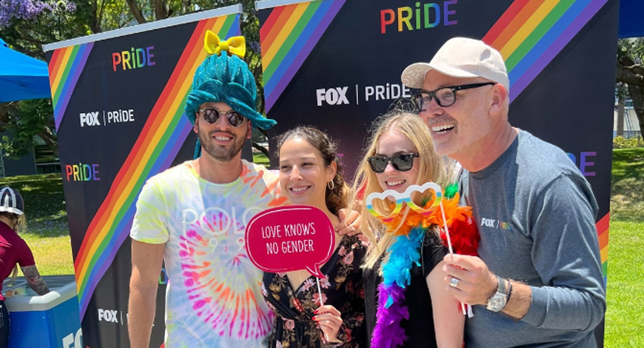 Three Fox Employees at a company Pride event